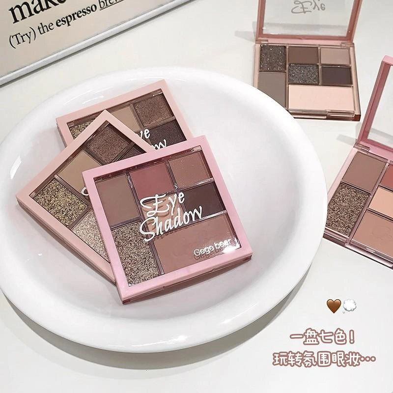 Makeup eyeshadow palettes on a white plate with visible brand name.