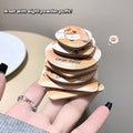 Stack of eight beauty blender with 'Gege Bear' branding held by a hand.