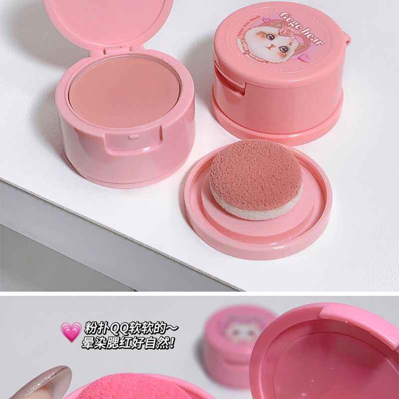 brown powder blush on a pink packaging on a white table 
