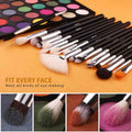 Set of makeup brushes with a color palette on an orange background