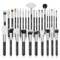 Set of makeup brushes with black handles and white bristles on a white background