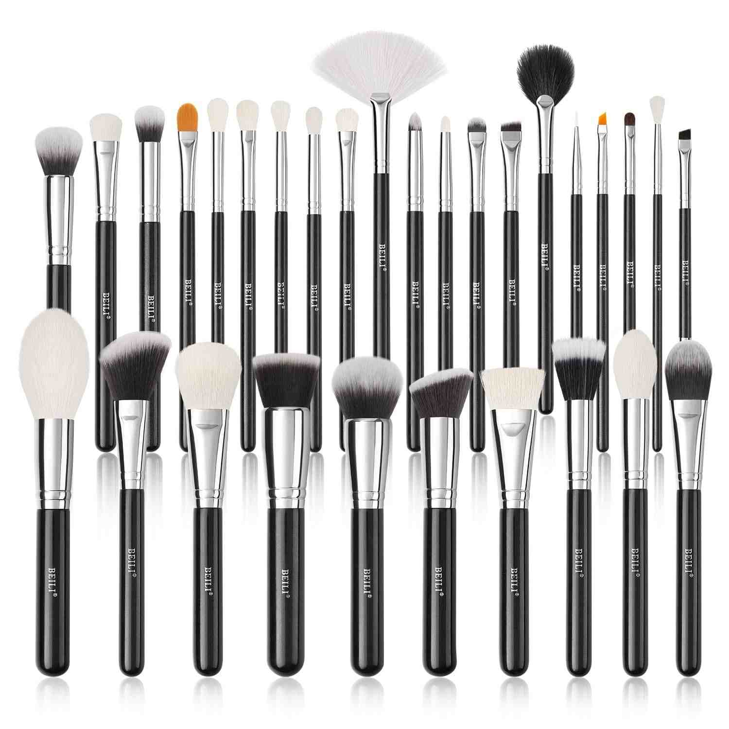Set of makeup brushes with black handles and white bristles on a white background