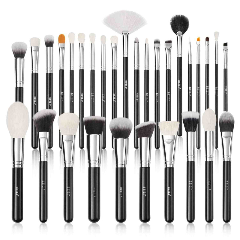 Set of makeup brushes with black handles and white bristles on a white background