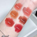Lipstick swatches on a person's arm with labels