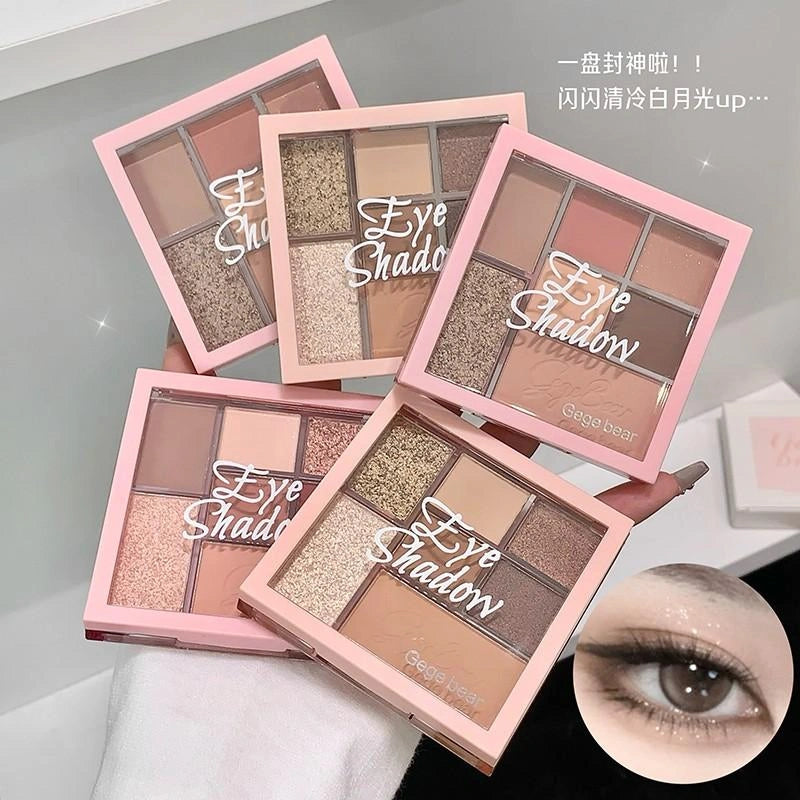 Multiple eye shadow palettes with a close-up of an eye wearing makeup.
