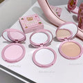 Set of  three compact powder with open covers on a white background