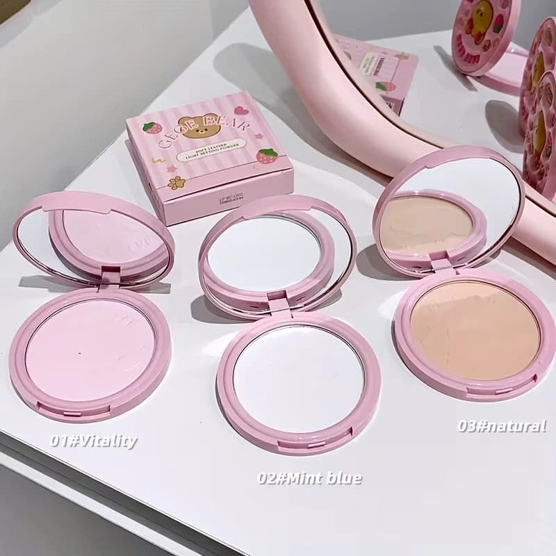 Set of  three compact powder with open covers on a white background