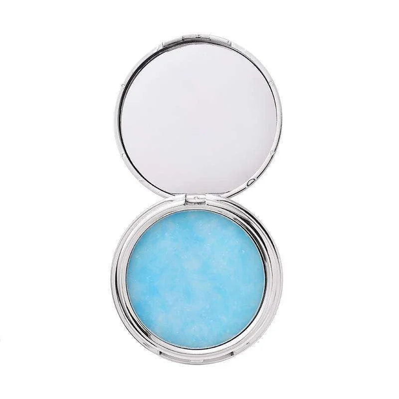 Compact powder with blue shade inside on a white background