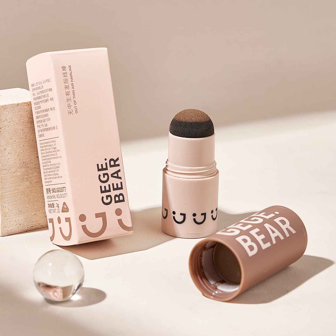 hair stick with smiley face design and packaging on a neutral background