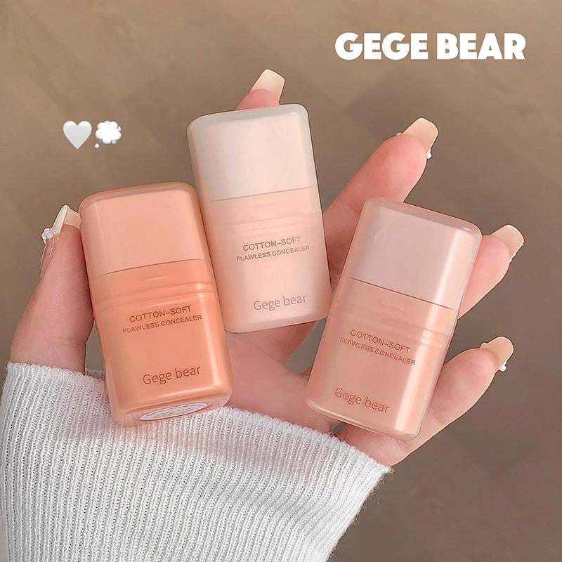 Three Gege Bear concealer bottles held in a hand against a neutral background