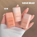 Three Gege Bear concealer bottles held in a hand against a neutral background