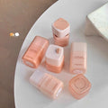 Set of Gege bear matte concealer with  dispenser bottles on a white surface
