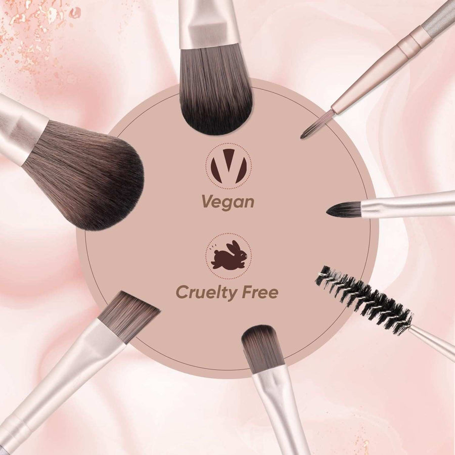 Makeup brushes arranged around a circular sign with 'Vegan' and 'Cruelty Free' text on a pink background.