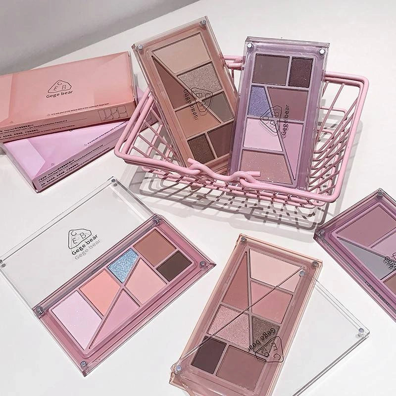 Makeup palettes with a pink and clear design on a white surface