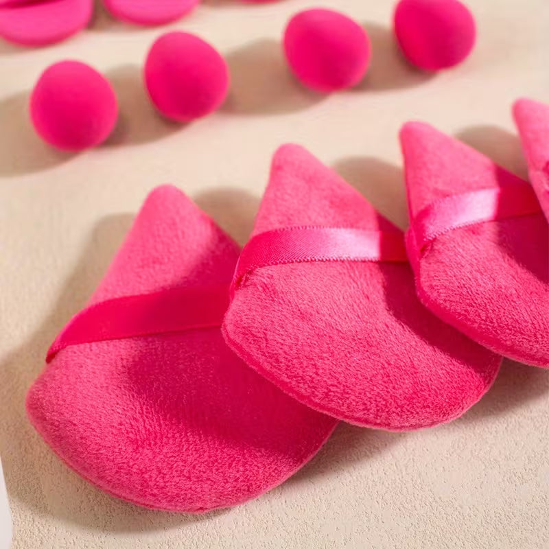 dark pink pizza puffs and mini makeup blender on a grey background 