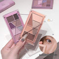 Set of small makeup palettes with various colors on a neutral background