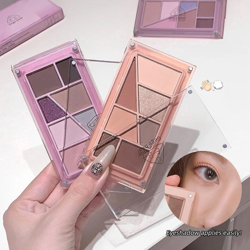 Set of small makeup palettes with various colors on a neutral background