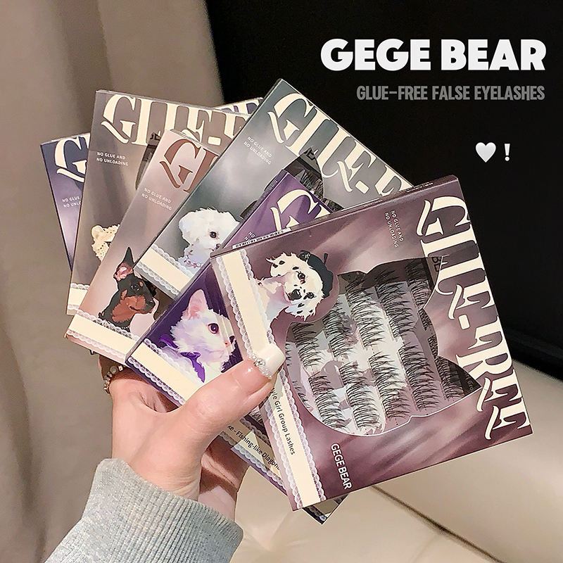 Hand holding GEGE BEAR glue-free false eyelashes packaging with product inside.