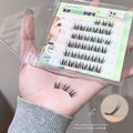 False eyelashes in a packaging box held by a person's hand.