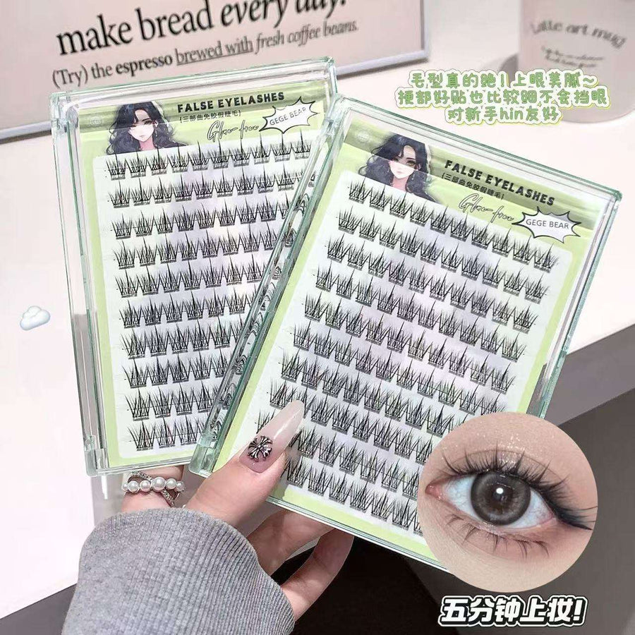 False eyelashes in packaging with a hand holding them, close-up of an eye wearing the lashes.