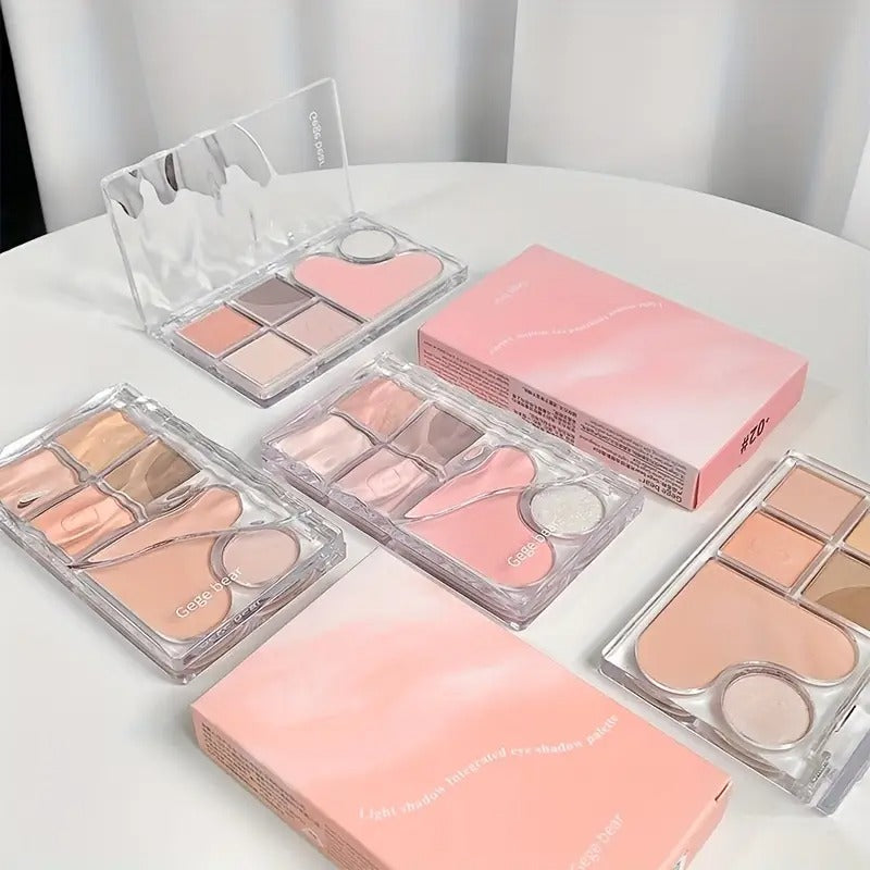 Makeup palettes with pink and clear packaging on a white surface