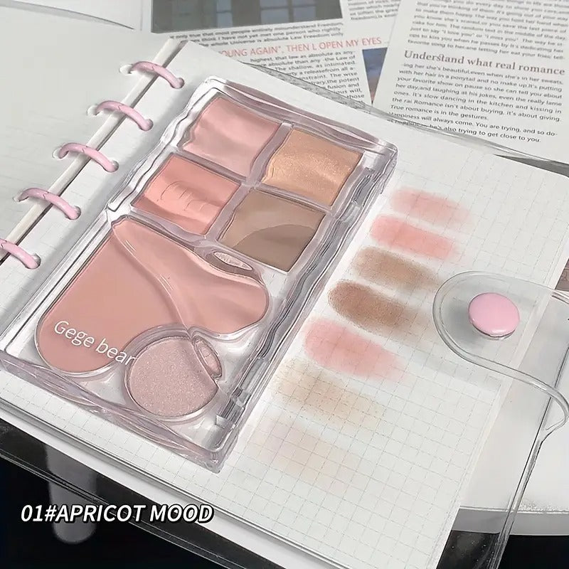 Makeup palette with shades of pink and beige on a notebook page