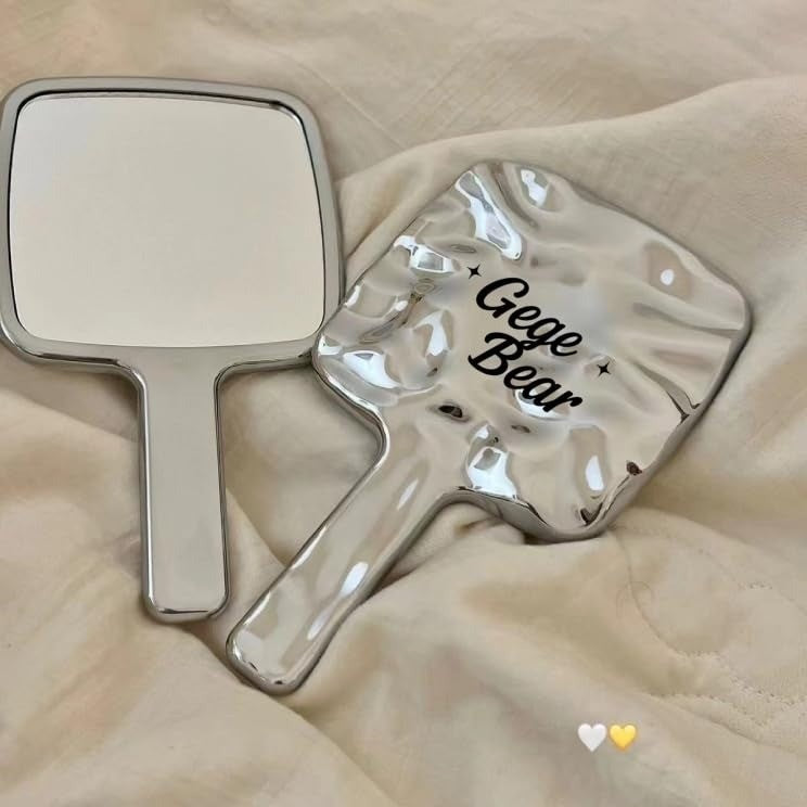 Handheld mirror and paddle with 'Gege Bear' branding on a beige surface