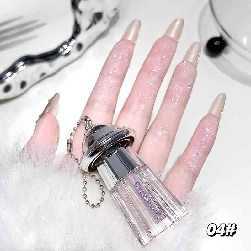 hand holding liquid shimmer eyeshadow finger cleary showing the shimmer and pigmenation on a white background 