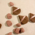 figer beauty blender and pizza puffs on a flat faint yellow surface 
