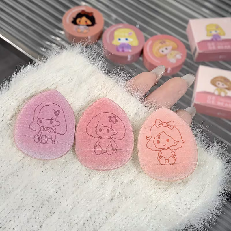 Set of finger puffs stamps with cartoon designs on a fluffy white surface.