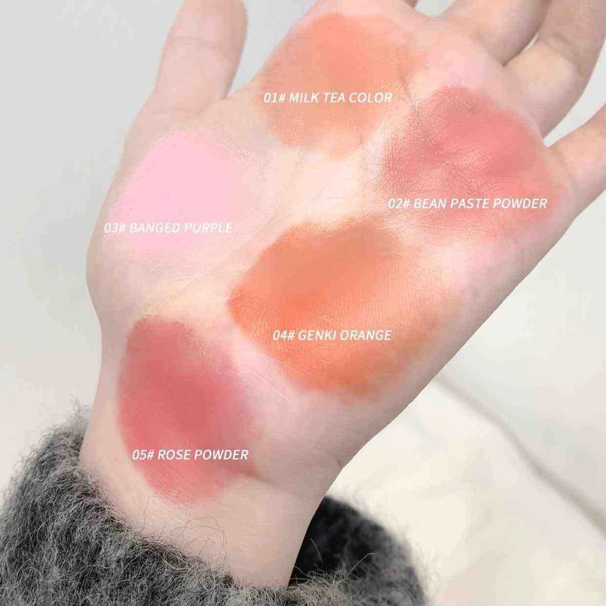 Hand with five different colored blush swatches labeled on a neutral background