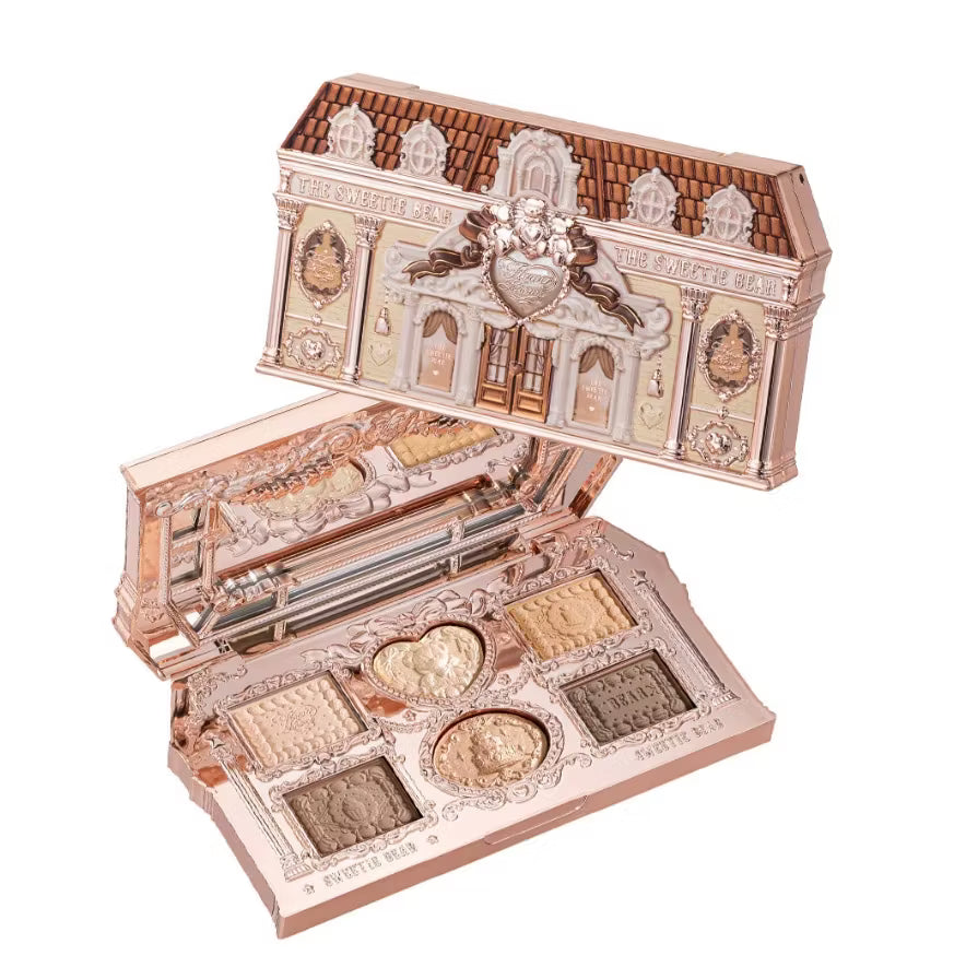An overhead close-up of an open Flowerknows Sweetie Bear 6-color eyeshadow palette, revealing a built-in mirror and beautifully embossed nude beige and warm latte matte and shimmer shades.