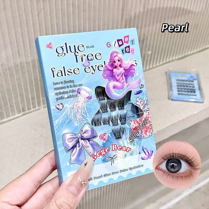 False eyelashes packaging with mermaid design and a close-up of an eye wearing the false eyelashes.
