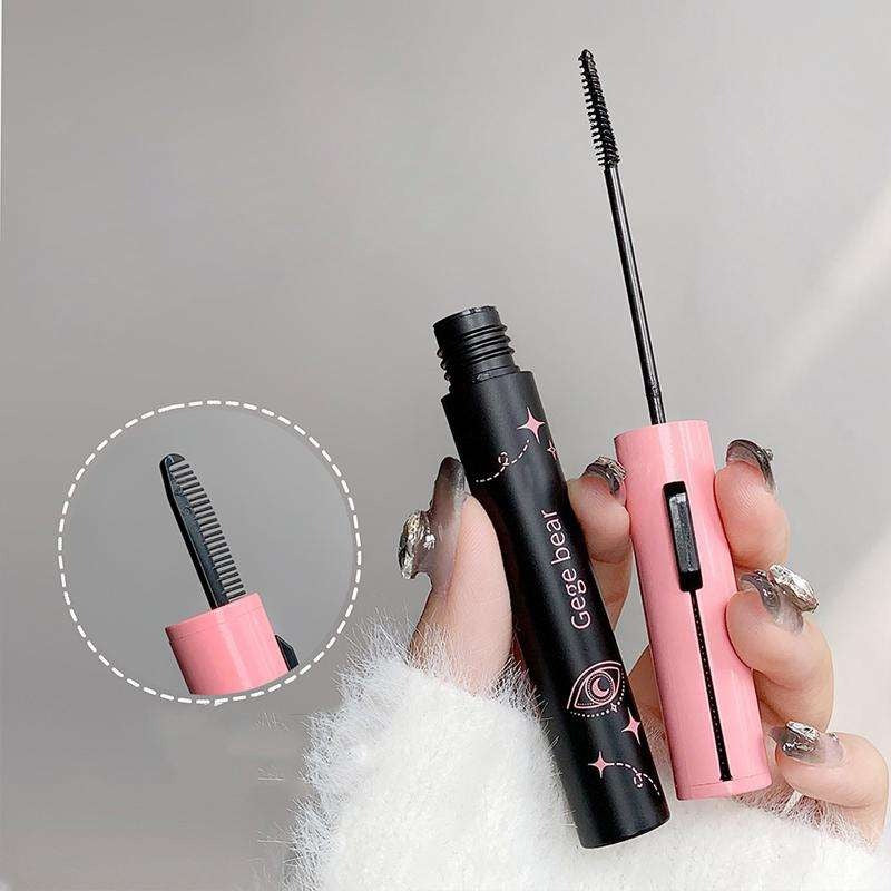 Two mascara products, one black and one pink, held by a hand with a gray background.