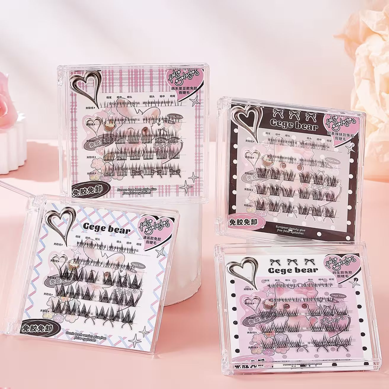 four sets of cluster eyelashes on a pink background 