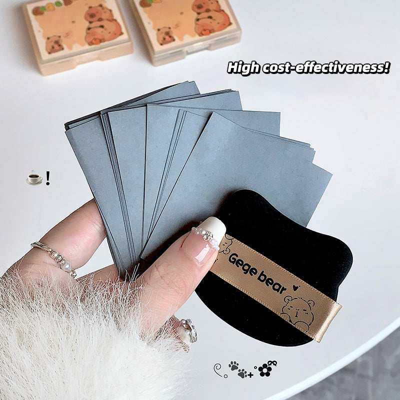 Gege Bear blotting paper for oily skin instant shine removal makeup touch up sheets a hand holding paper and puff