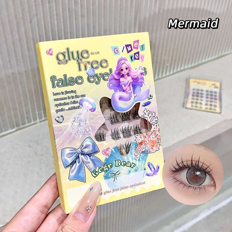 False eyelashes packaging with mermaid design held by a hand, close-up of an eye wearing the lashes.