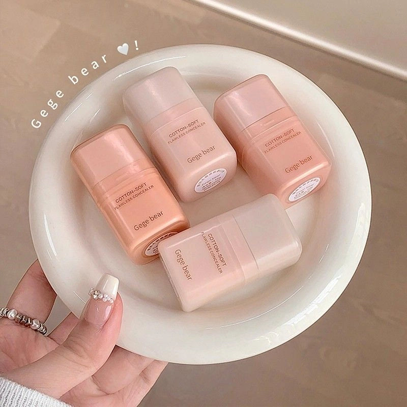 four concealer bottles labeled 'Gege bear' on a white plate held by a hand.