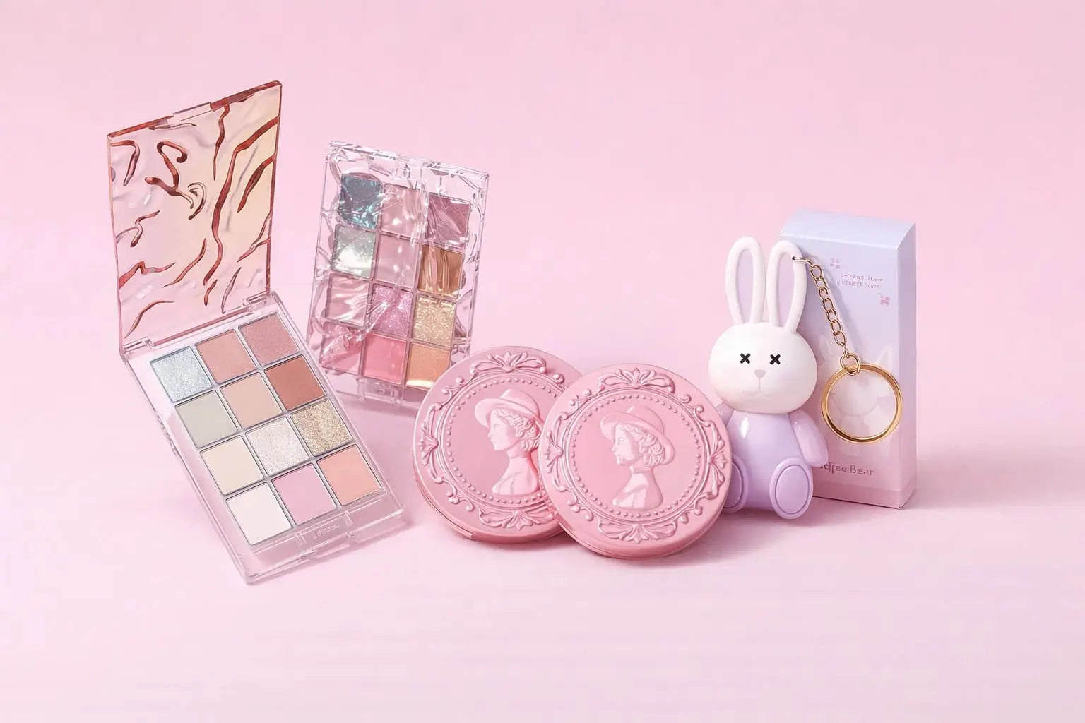 Makeup products and accessories on a pink background