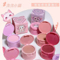 Pink blush compact with packaging and cartoon character on a white background