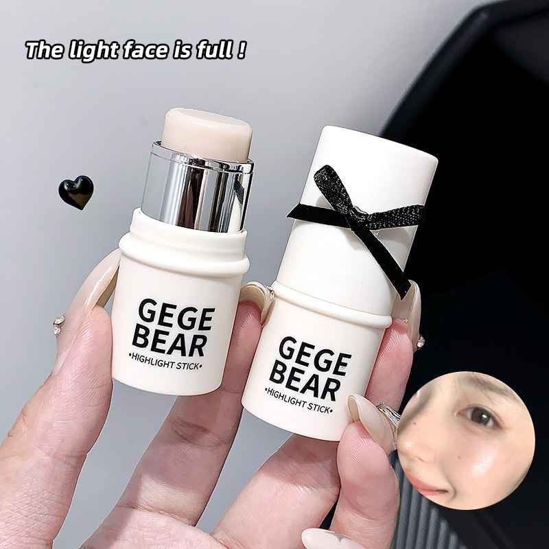 Two gege bear Blushes held by a hand with a blurred face in the corner.