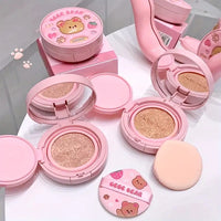 Pink makeup foundation products with bear design on a white background