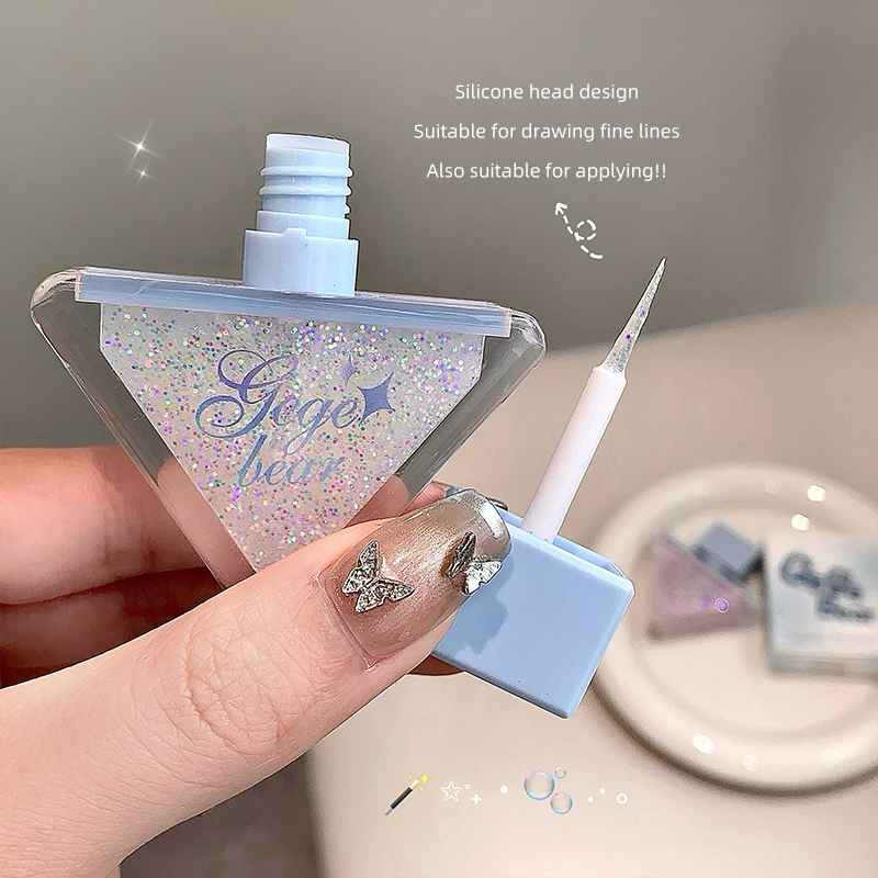 gege bear liquid shimmer eyeshadow in white pink glitter held by a hand and wand is visible 