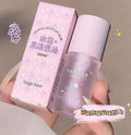 Crystal jelly lip oil with packaging held by a hand on a neutral background grapes flavoured 
