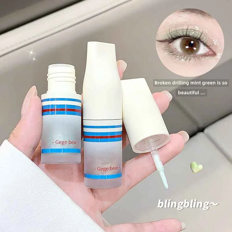 green liquid shimmer eyeshadow stick with 'Gege bear' branding held by a hand, with an inset of an eye wearing the product.