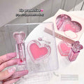 pink lip gloss set with heart shaped lip balm  a hand holding the set 