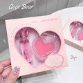 plant extact lip care set showing heart knob clear lip oil and lip balm 'gege bear' brand cleary visible in the packet held by a hand of  a lady 