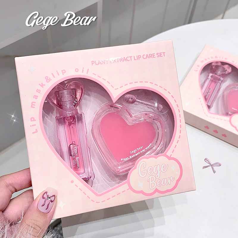 plant extact lip care set showing heart knob clear lip oil and lip balm 'gege bear' brand cleary visible in the packet held by a hand of  a lady 