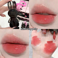 Collage of a lip gloss applicator, close-up of lips with gloss, and gloss swatches on skin.