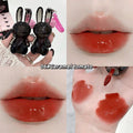 Lip gloss with rabbit-shaped applicator and color swatches on skin